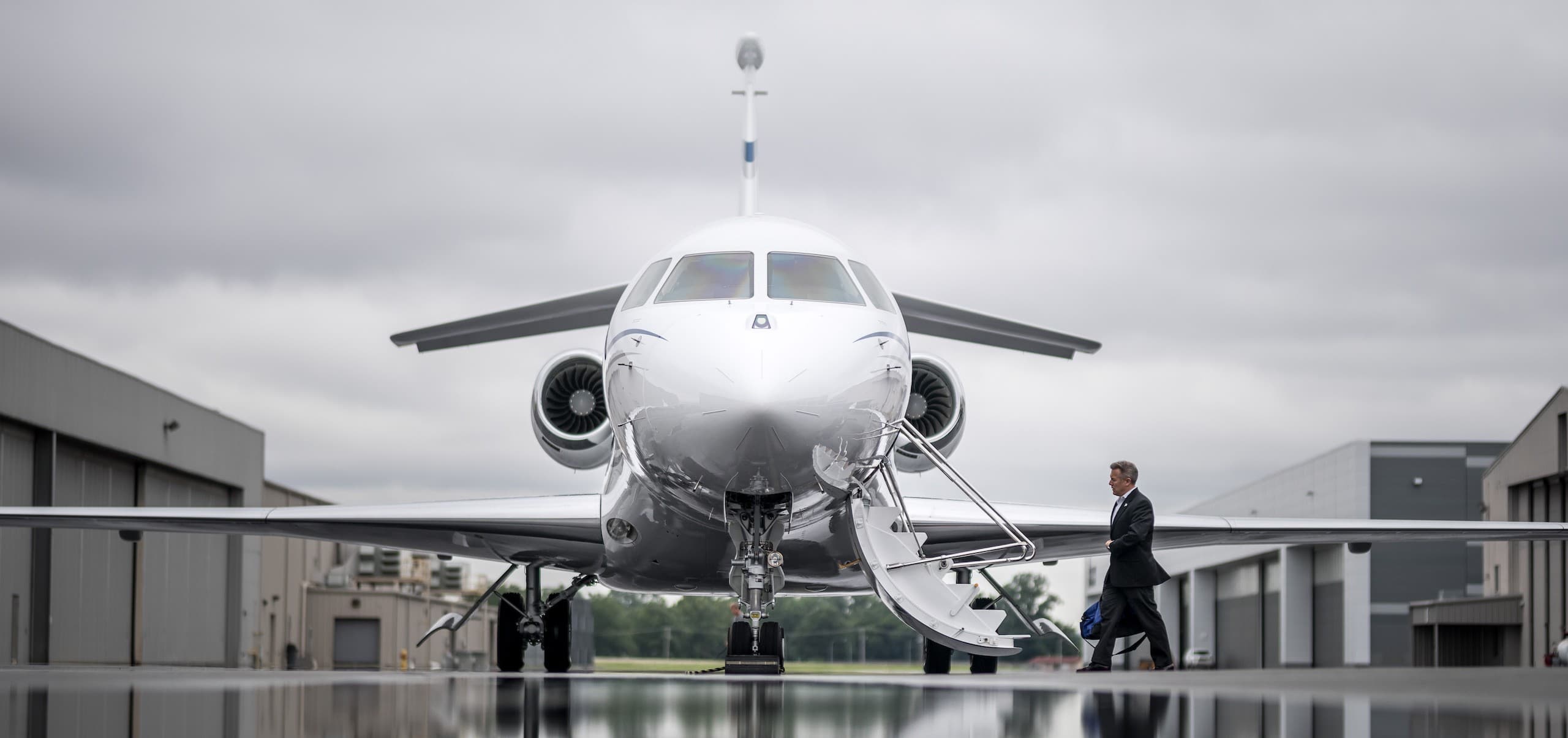 Dassault Falcon business jet on the tarmac with stairs down